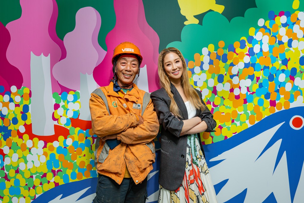 Cathy Lee (right), daughter-in-law of Henderson Land’s founder,  poses with a construction worker at the site. She says the decoration aims to give residents a chance to pause amid their busy lives. Photo: Handout