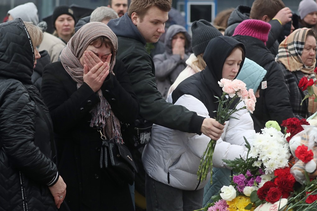 People mourn and bring flowers at the Crocus City Hall concert venue following a terrorist attack. Photo: EPA-EFE