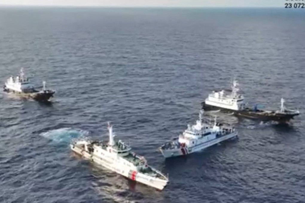 A still from aerial footage taken on Saturday by the Philippine Coast Guard (PCG) shows a Chinese coastguard ship and “Chinese maritime militia” vessels surrounding a PCG ship on a resupply mission. Photo: PCG/Handout via AFP