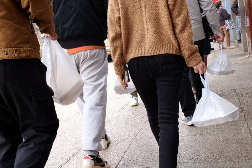People with takeaway food in Hong Kong’s Yau Ma Tei district on January 29. Starting from April 22, restaurants cannot offer customers any polystyrene products for takeaway services. Photo: Jelly Tse