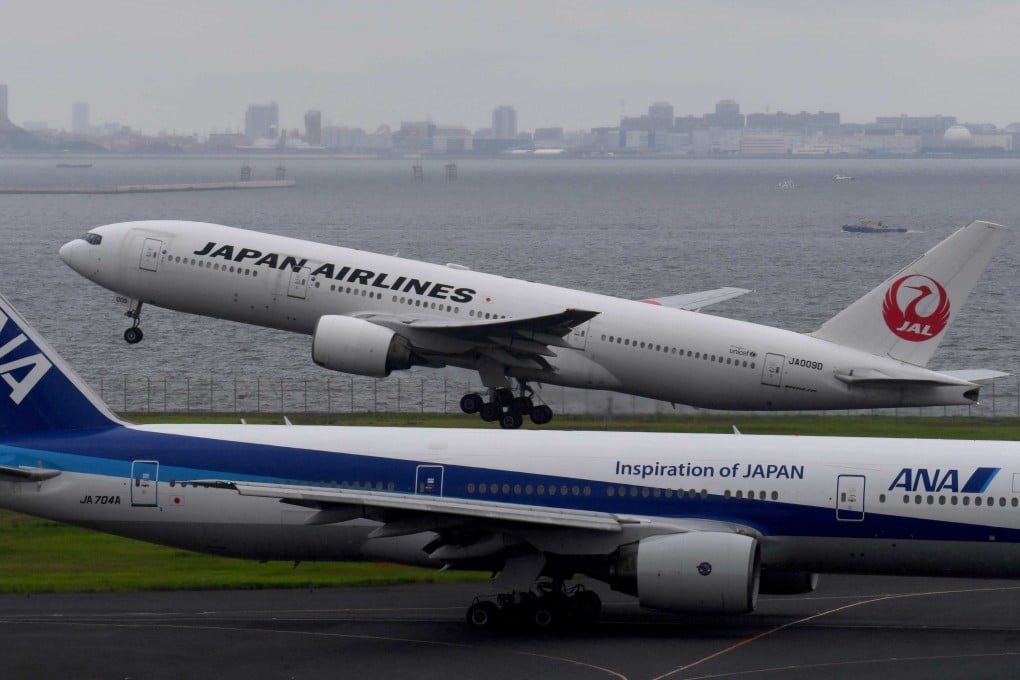 A Japan Airlines (JAL) passenger jet taking off next to an All Nippon Airways (ANA) jet at Haneda International Airport in Tokyo. Photo: AFP