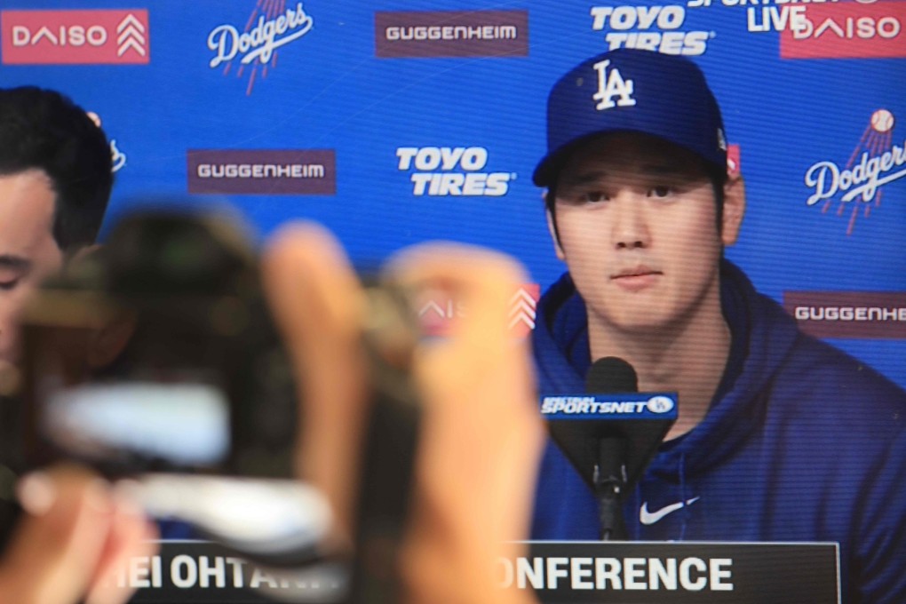 Shohei Ohtani delivers a statement during a closed press conference as seen on a TV in the press box at Dodger Stadium in Los Angeles. AFP