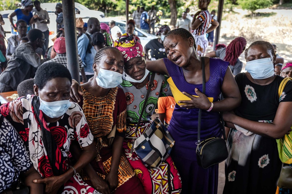Women belonging to the same family hold each other as they mourn after receiving the remains of several other family members who were victims of a Kenyan starvation cult, at a private mortuary in Malindi. Photo: AFP