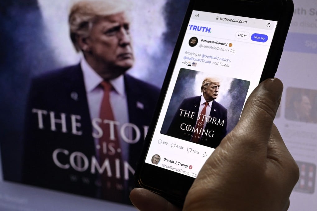 Former US president Donald Trump’s Truth Social account on a mobile device with an image of Trump in the background in Washington, DC on September 13, 2022. Photo: AFP