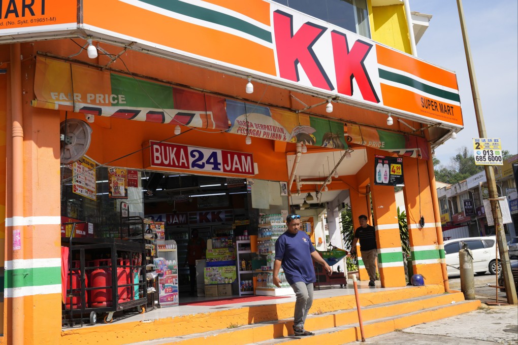 A customer walk out from KK Mart convenience store in Puchong area on the outskirts of of Kuala Lumpur. KK Super Mart and its supplier has apologised for the socks. Photo: AP