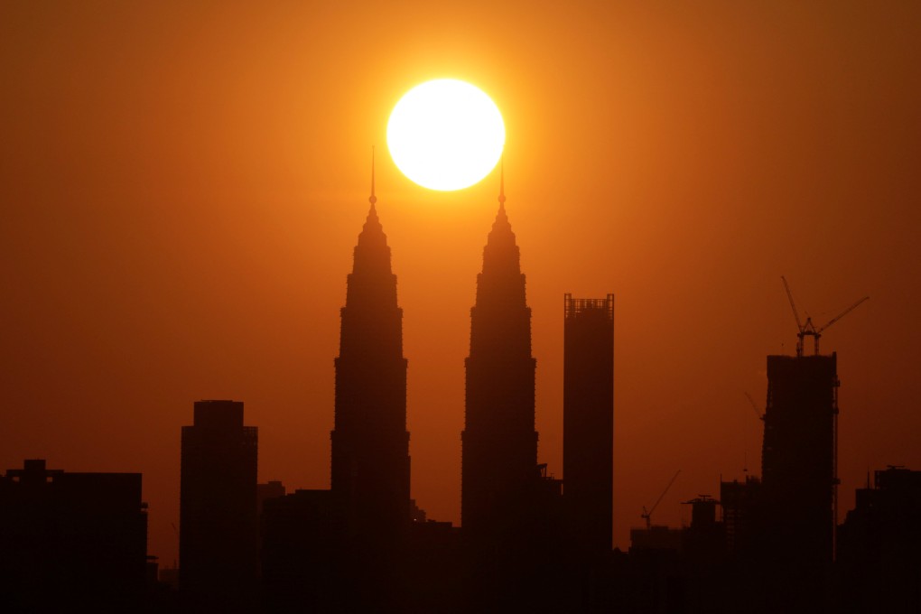 The sun sets behind the Petronas Twin Towers in Kuala Lumpur. Malaysia is using drones to survey peatlands susceptible to catching fire and monitoring dwindling water levels in dams. Photo: Reuters