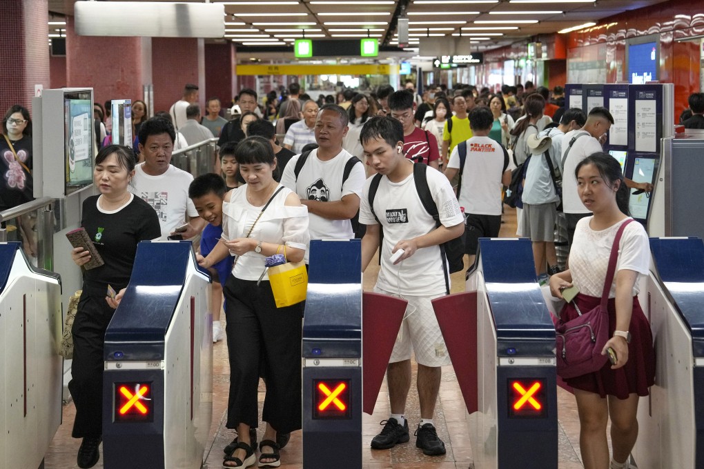 Passengers passing through payment gates of Mong Kok MTR station. The fare adjustment mechanism is set to be used for five financial years. Photo: Elson Li