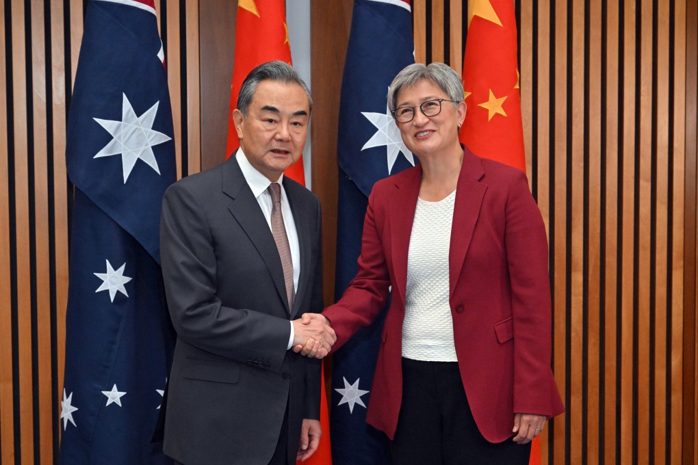 China’s foreign minister, Wang Yi, and Australia’s foreign minister, Penny Wong, shake hands in Parliament House on March 20. Photo: dpa