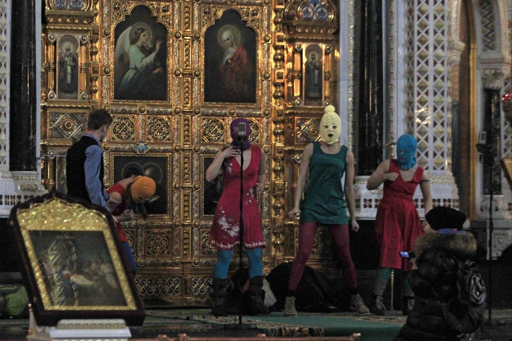 Masked members of Russian feminist group Pussy Riot protest inside the Christ the Savior Cathedral in Moscow in 2012. On Wednesday, Russia sentenced band member Lyusya Shtein to six years in prison in absentia for anti-war social media posts. Photo: AP