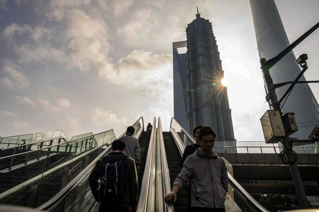 Pedestrians ride escalators in Pudong’s Lujiazui financial district in Shanghai on January 29, 2024. Photo: Bloomberg