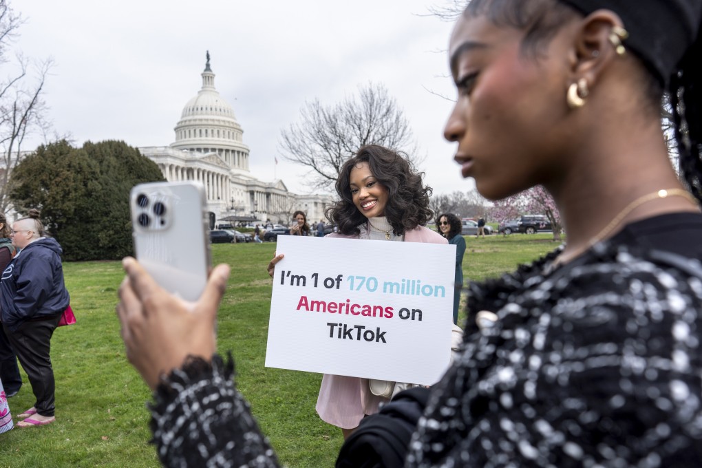 Two devotees of TikTok, Mona Swain (centre) and her sister  Rachel Swain (right), pose with a sign expressing their support at the US Capitol on March 13. Photo: AP