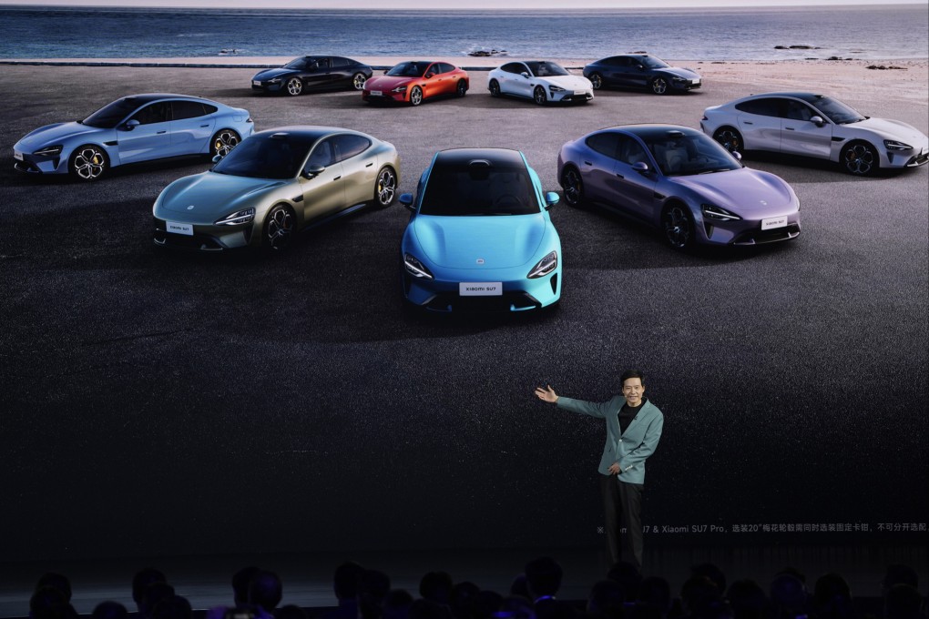 Xiaomi founder Lei Jun shows off the multiple colours of the SU7. Photo: AP.