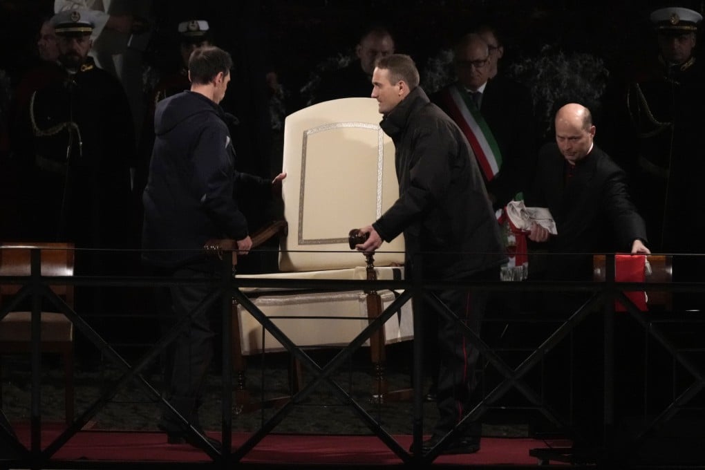Vatican ushers carry away Pope Francis’ chair before the start of the “Way of the Cross” event at the Colosseum on Good Friday. Photo: AP