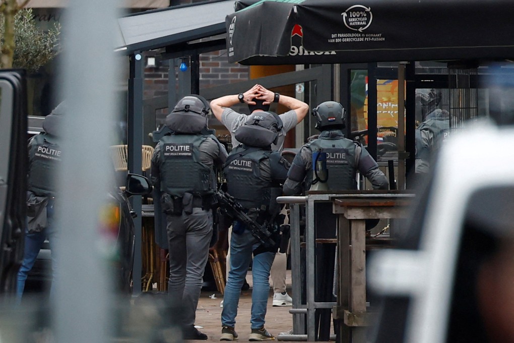 Dutch police detain a person near the Cafe Petticoat, where several people were being held hostage in Ede, Netherlands on Saturday. Photo: Reuters