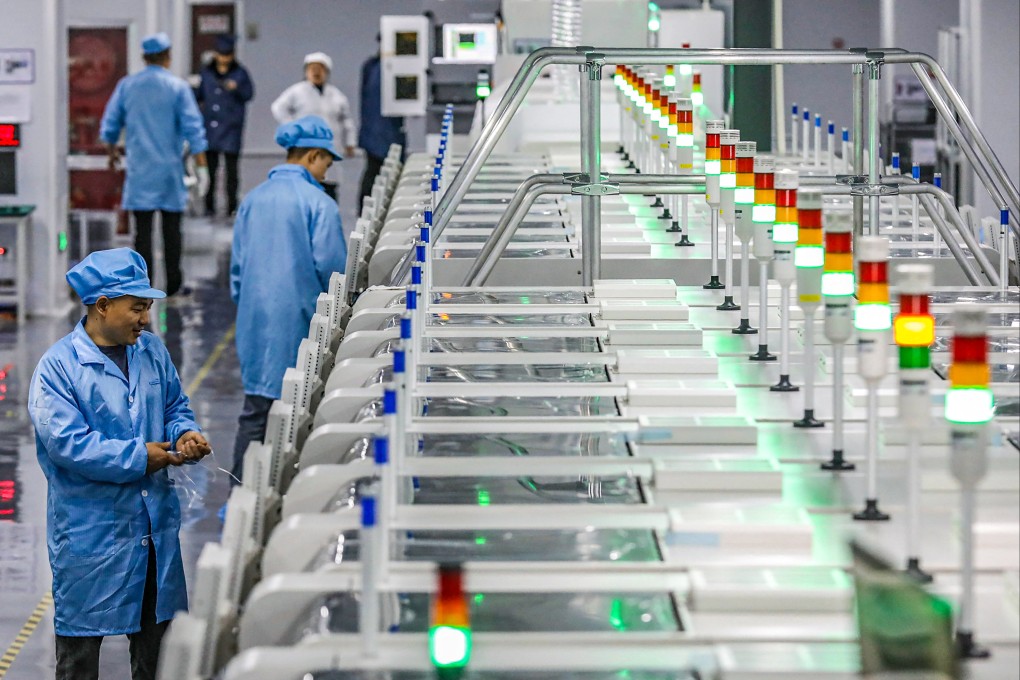 Employees work at an LED display factory in eastern China’s Jiangsu province on March 28. Photo: AFP