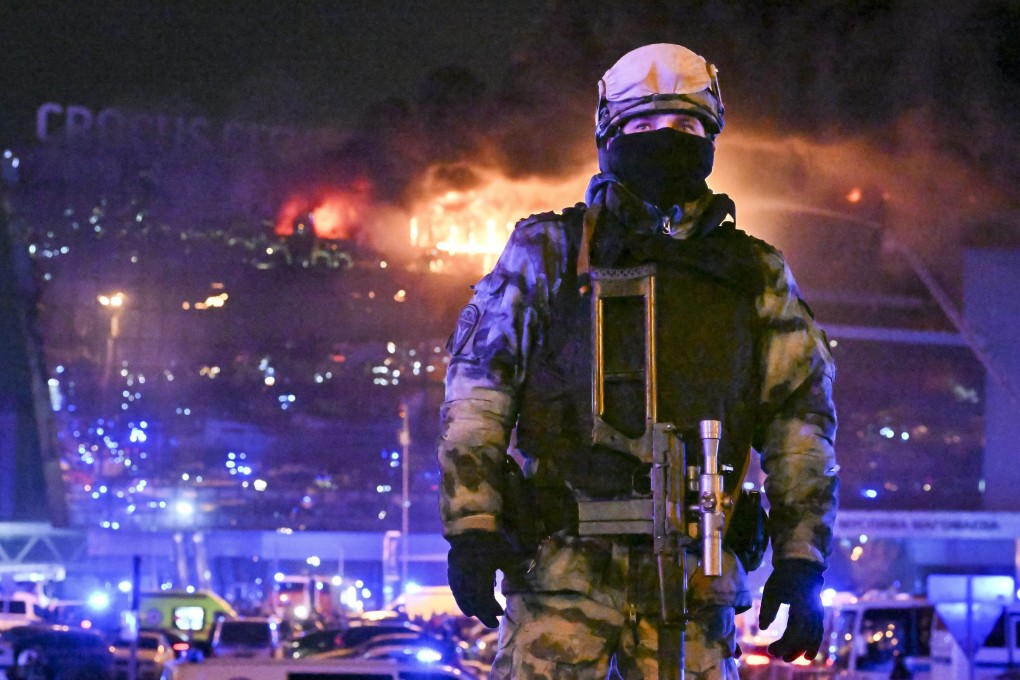 A Russian soldier secures the area as a massive blaze burns in the Crocus City Hall concert venue on March 22 following a deadly attack claimed by Isis. Photo: AP