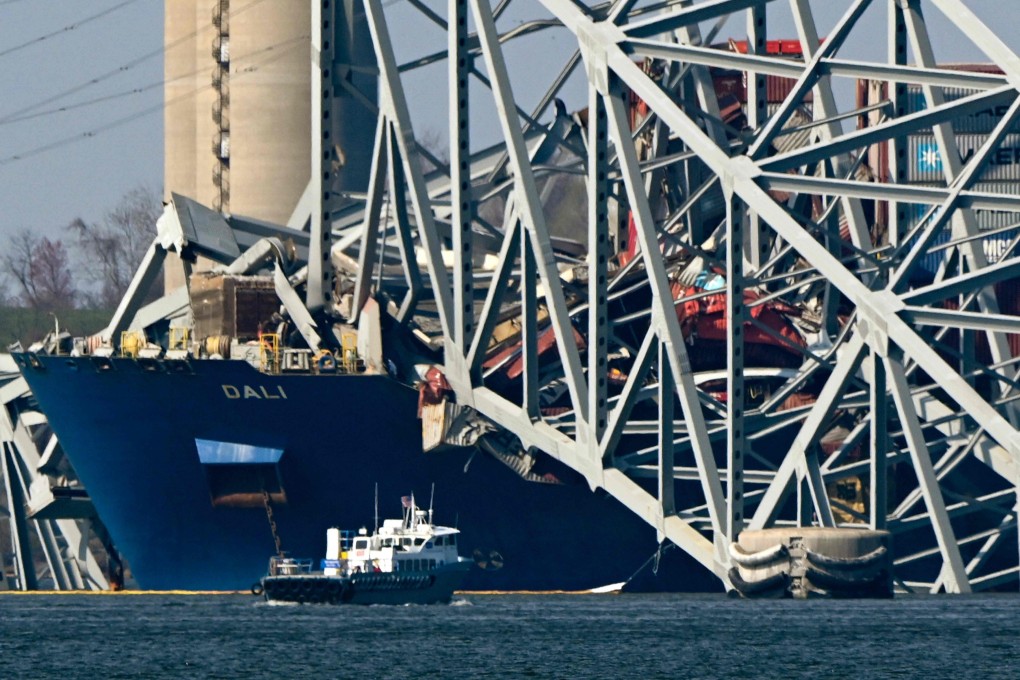 The collapsed Francis Scott Key Bridge lies on top of the container ship Dali in Baltimore, Maryland on March 29 as clean-up work begins. Photo: AFP