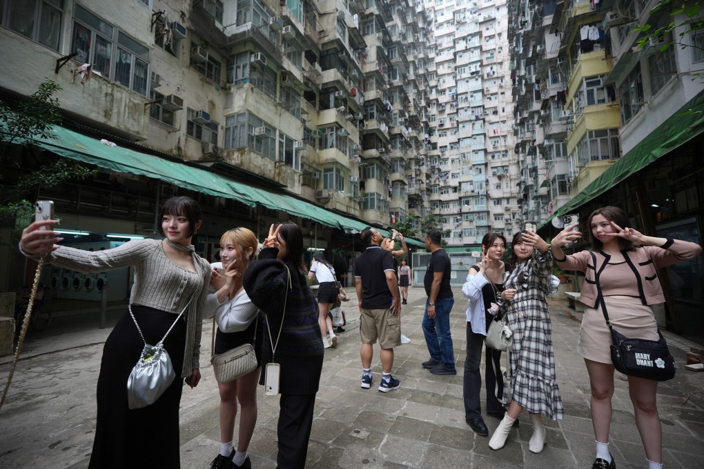 Tourists take pictures near the Yick Cheong Building, also known as the “Monster Building”, in Quarry Bay, Hong Kong. Photo: Eugene Lee