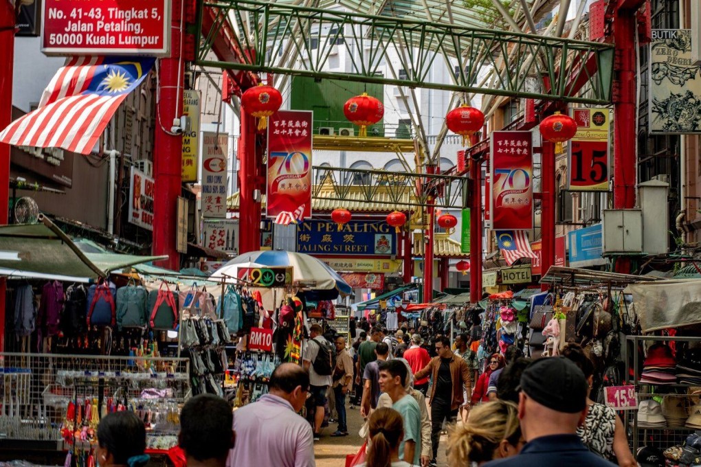 Shoppers and tourists walk through Chinatown in Malaysia’s capital Kuala Lumpur earlier this year. Photo: Bloomberg