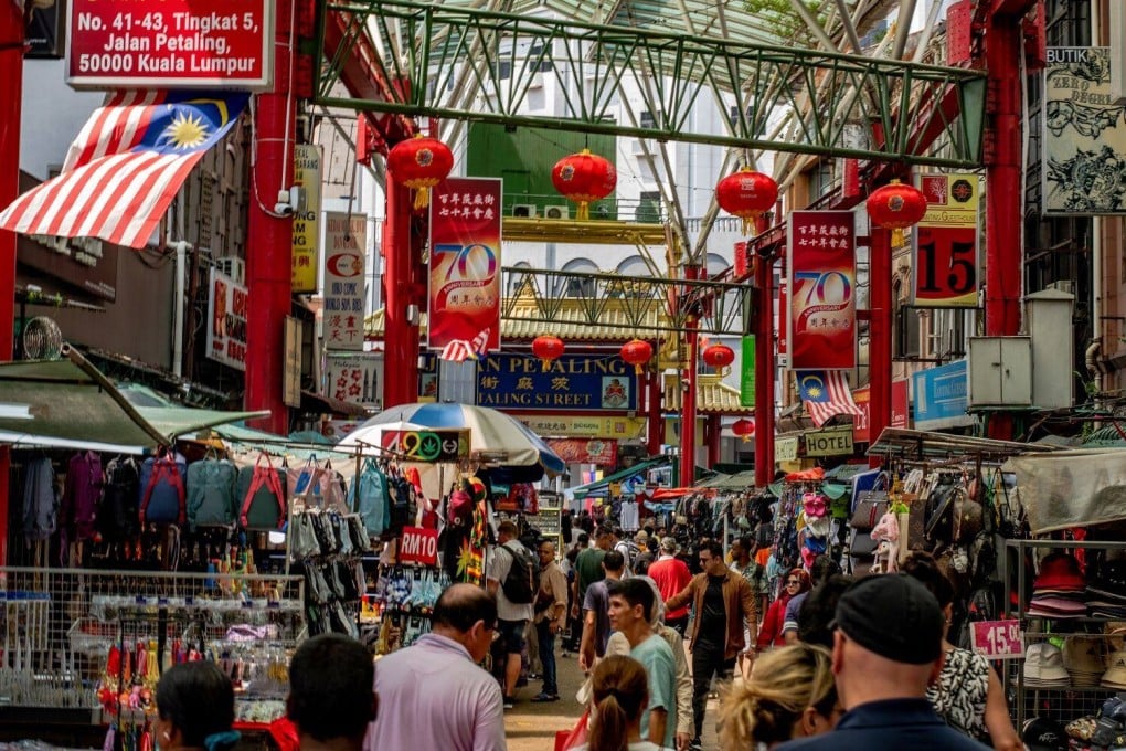 Shoppers and tourists walk through Chinatown in Malaysia’s capital Kuala Lumpur earlier this year. Photo: Bloomberg