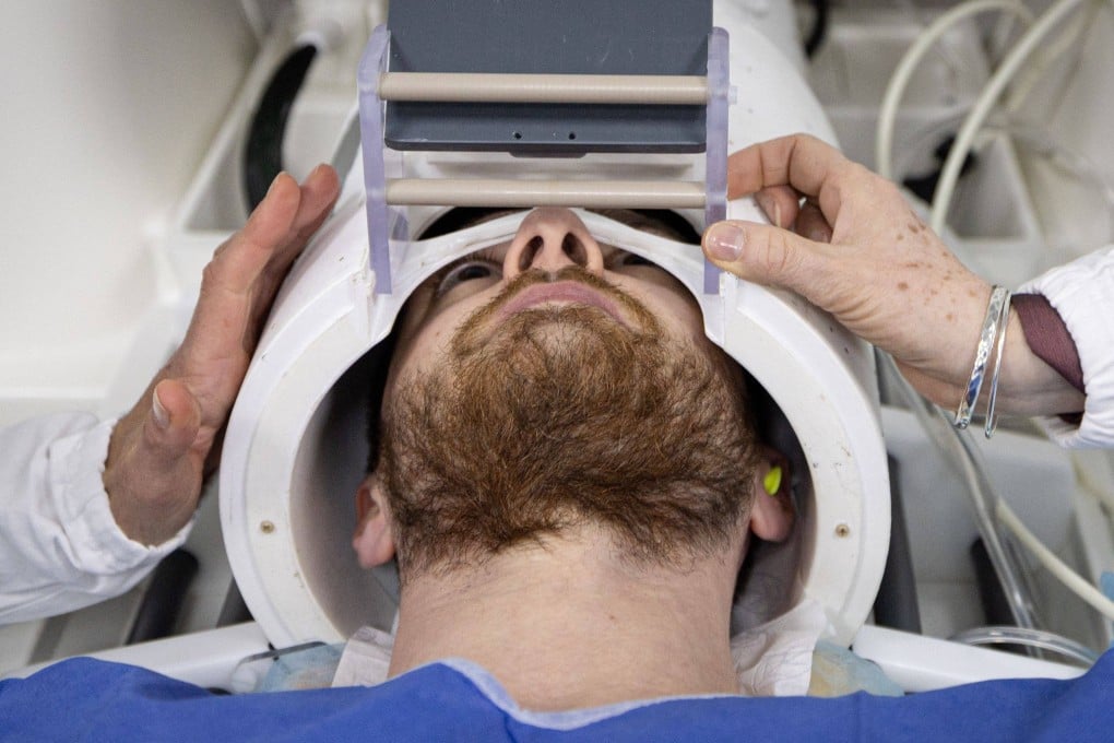 A volunteer takes part in an MR exam simulation. “Iseult”, the world’s most powerful MRI scanner, has delivered its first images of the human brain. Photo: AFP