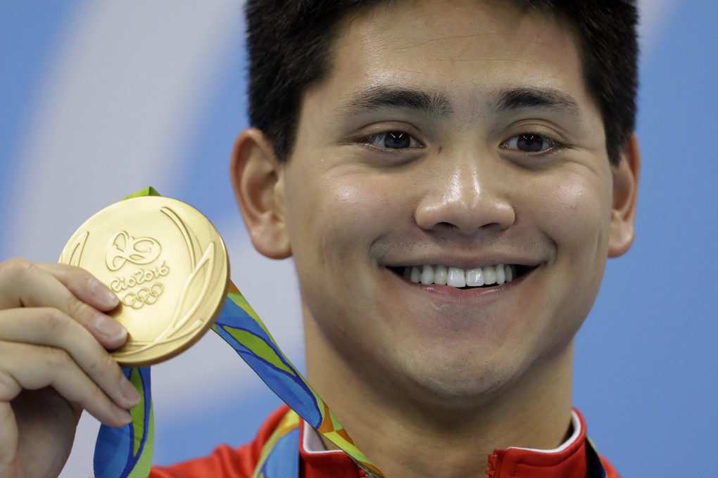 Singapore’s Joseph Schooling shows off his 100m butterfly gold medal in Rio. Photo: AP