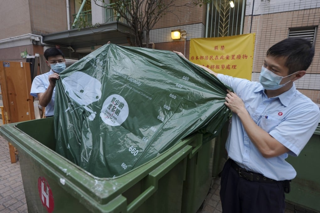 Property management officers with designated bags for waste disposal at On Ning House, Moon Lok Dai Ha, in Tseun Wan. Photo: Eugene Lee