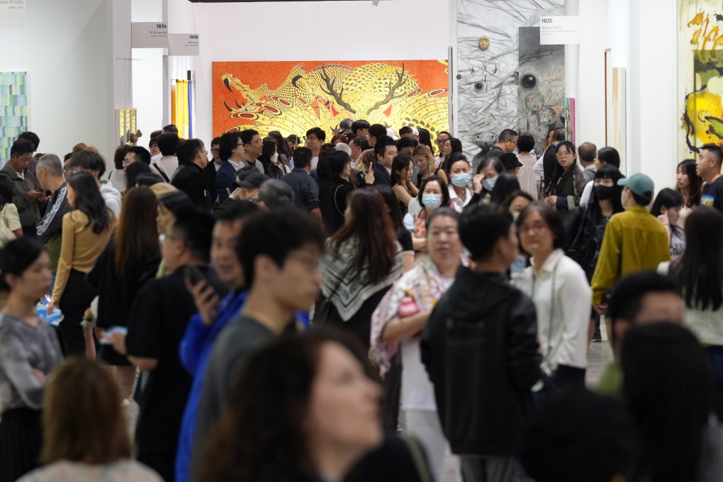 Visitors admire artworks at Art Basel Hong Kong, the highlight of Art Week in the city, as the contemporary art fair opens for public visitors at the Hong Kong Convention and Exhibition Centre in Wan Chai. Photo: Eugene Lee