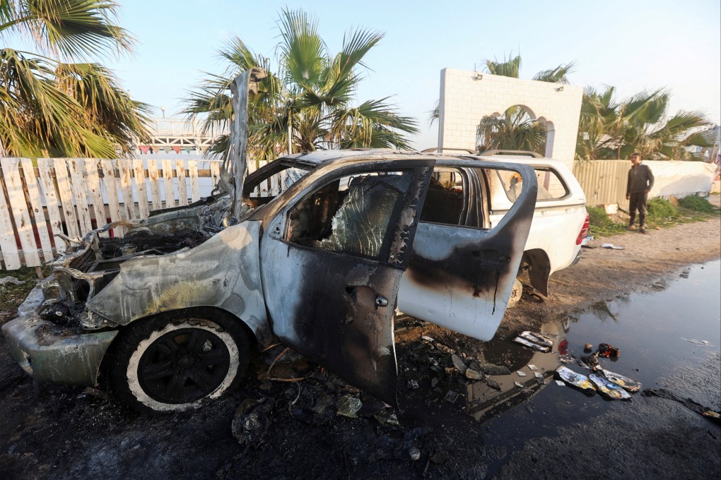A man looks at a vehicle where employees from the World Central Kitchen, including foreigners, were killed in an Israeli airstrike. Photo: Reuters