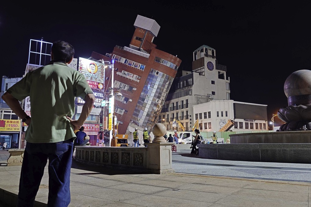 A man looks at the cordoned-off site of a leaning building in the aftermath of an earthquake in Hualien in eastern Taiwan on Wednesday. Photo: AP