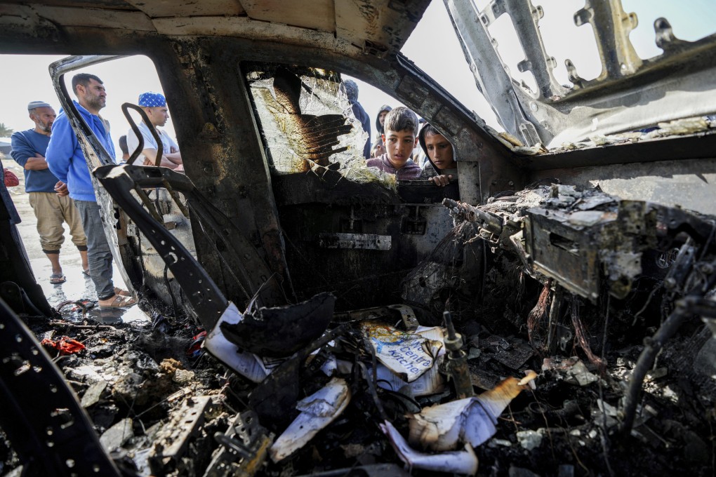 People inspect the site on Tuesday where World Central Kitchen workers were killed in Deir al-Balah, Gaza Strip. Photo: AP
