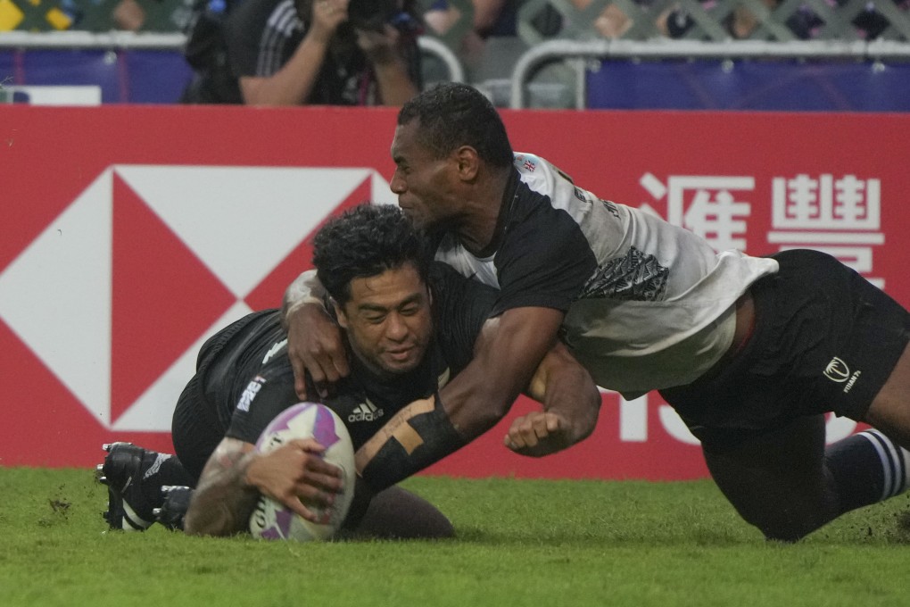 New Zealand’s Regan Ware scores a try despite the attentions of Fiji’s Filipe Sauturaga. Photo: Sam Tsang