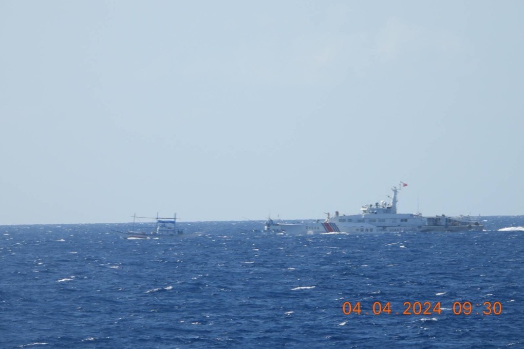A Chinese coastguard vessel approaches a Philippine fishing vessel in the South China Sea on Thursday, in a photo supplied by the Philippine Coast Guard. Photo: handout via Reuters