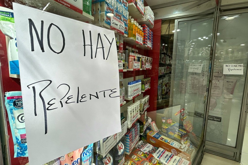 A sign reading “We Do Not Have Repellent” is displayed on the window of a store in Buenos Aires on Tuesday. Photo: AFP
