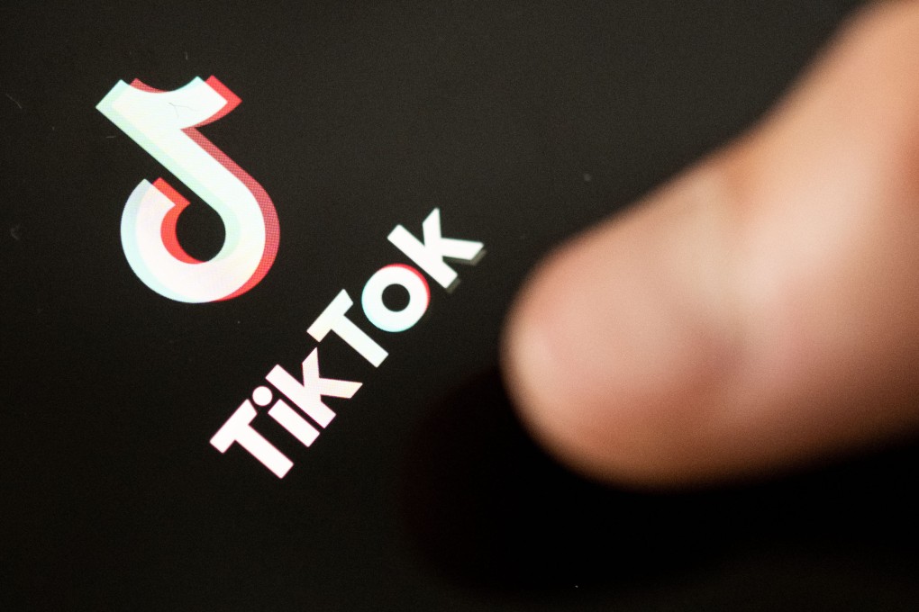 A teenager taps the TikTok logo on a smartphone. Photo: dpa