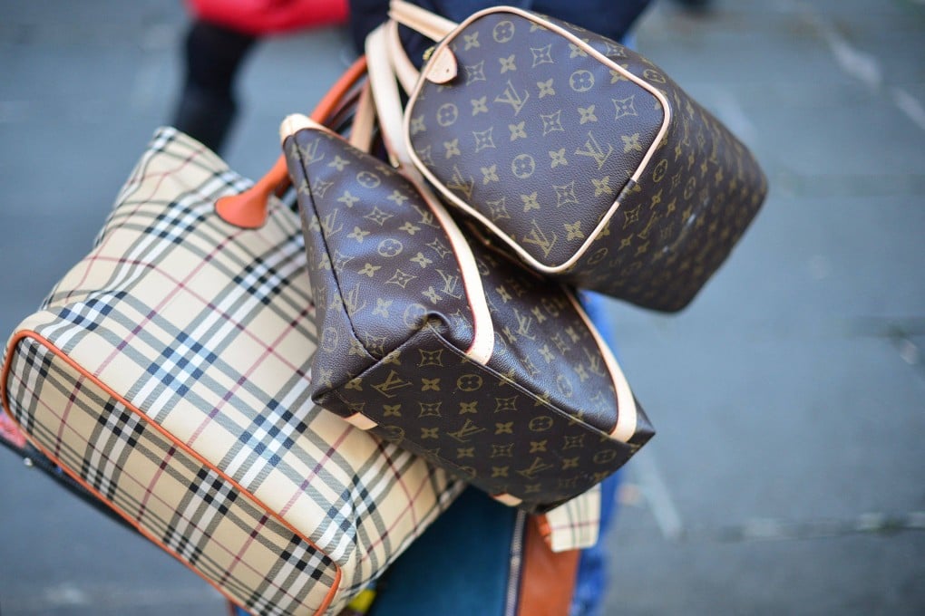 A seller carries counterfeit bags in a street in Rome. Italy’s estimated US$6.5 billion-US$7.5 billion market in counterfeit luxury goods, centred on Naples, generates money for the mafia. Photo: AFP