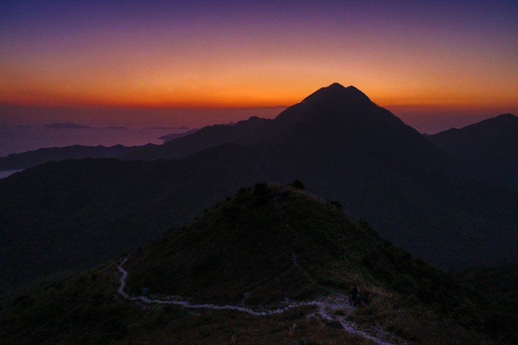 The waters around Lantau Island shimmer in the sunset as seen from Hong Kong’s third highest mountain on November 1, 2023. The government’s plan to reclaim land in the waters off Lantau have sparked much debate. Photo: Dickson Lee