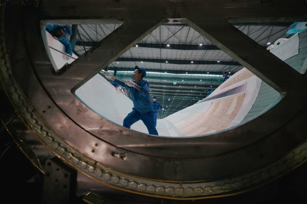 Employees assemble a wind turbine blade at a factory in Yancheng, Jiangsu province on November 16 last year. Photo: EPA-EFE