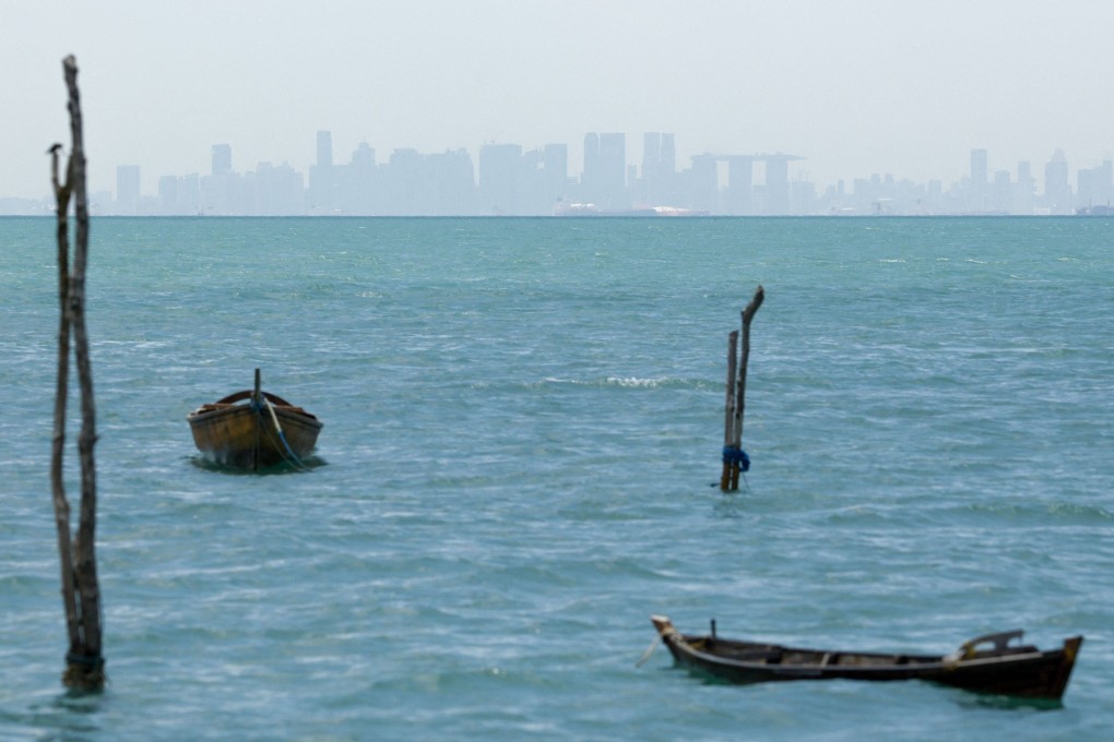 The skyline of Singapore is seen shrouded in haze past watercraft as seen from Batam in Indonesia’s Riau Islands. Photo: AFP