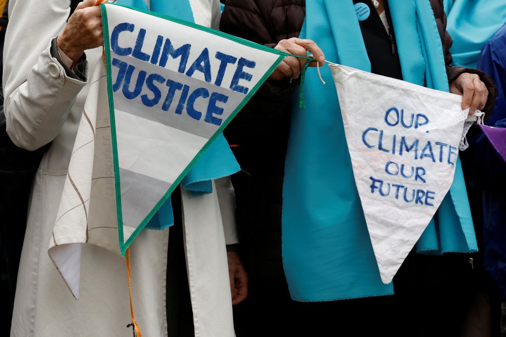 Supporters and members of the association Senior Women for Climate Protection hold banners as they arrive for the ruling of a climate case at the European Court of Human Rights (ECHR) in Strasbourg, France on Tuesday. Photo: Reuters