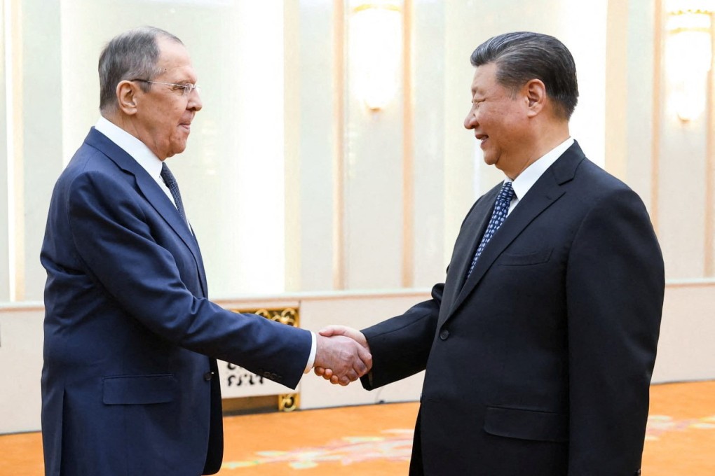 Russian Foreign Minister Sergei Lavrov greets with Chinese leader Xi Jinping in Beijing on Tuesday. Photo: Russian Foreign Ministry/Handout via Reuters
