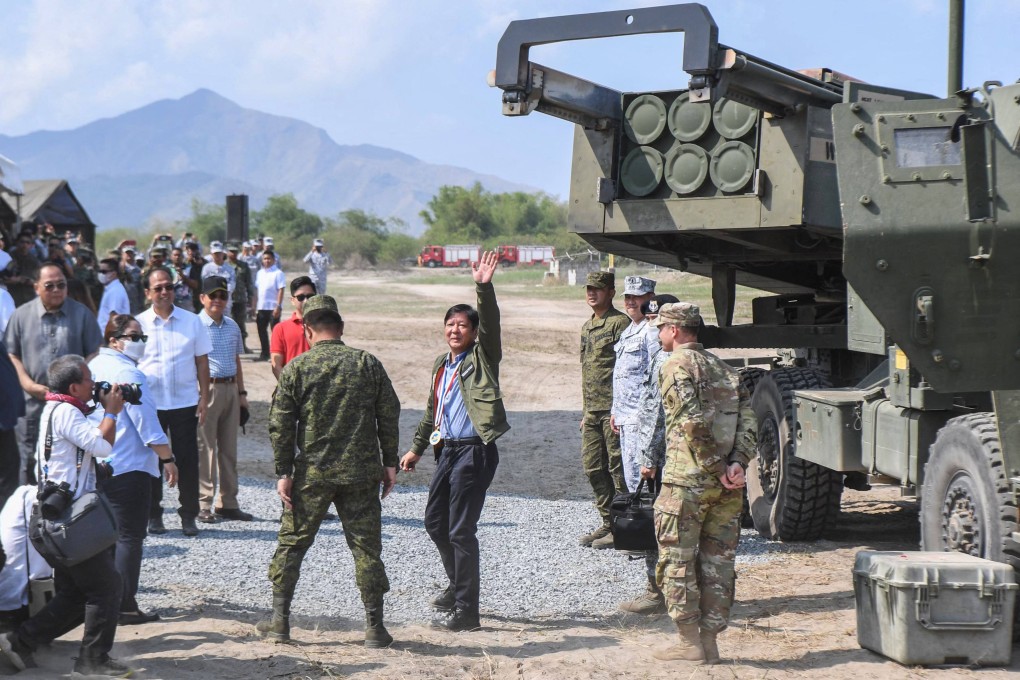 This photo taken on April 26, 2023 shows Philippine President Ferdinand Marcos (centre) waving to photographers at a US-Philippines Balikatan joint exercise at the naval training base in San Antonio, Zambales province. Photo: AFP