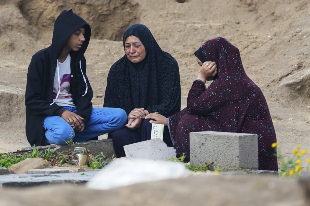 Palestinians visit the graves of their relatives who were killed in the war between Israel and the Hamas militant group on the first day of the Muslim holiday of Eid al-Fitr, in Deir al-Balah, Gaza on Wednesday. Photo: AP