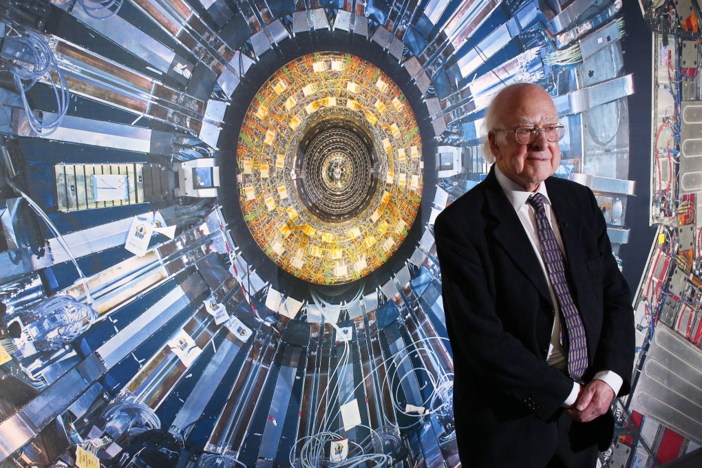 Professor Peter Higgs in front of a photo of the Large Hadron Collider. File photo: TNS