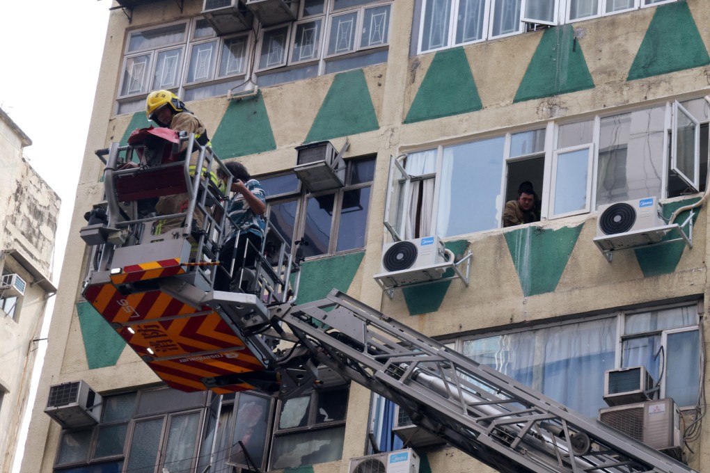 Firefighters rescue residents of New Lucky House on Wednesday. Five people died in the blaze. Photo: Jelly Tse