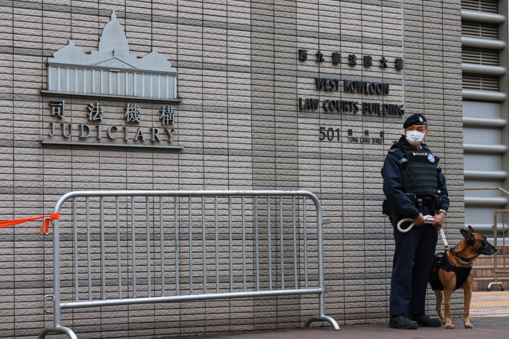 Police stand guard outside West Kowloon Court. Jimmy Lai’s trial has entered its 58th day. Photo: Yik Yeung-man