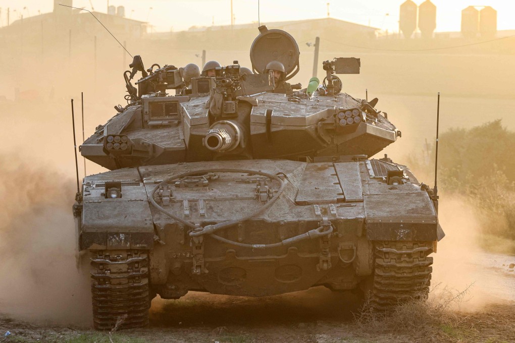 An Israeli military tank rolls near the border with the Gaza Strip, as mediators try to come to a resolution for a truce in the conflict. Photo: AFP