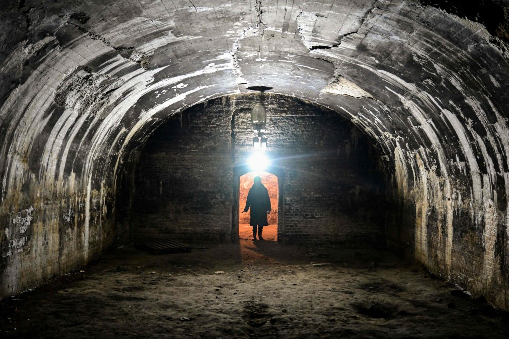 Niculina Moica, 80, detained as a teenager at Jilava prison in Romania under its then Communist regime, stands at the door of an isolation room used to punish political detainees imprisoned there. She is campaigning for the prison to be preserved as a monument. Photo: AFP