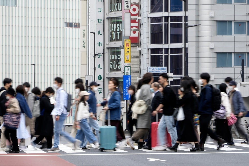 Pedestrians in Shinjuku’s business and shopping district in Tokyo. Japan continues to grapple with a declining birthrate and a rapidly greying society. Photo: EPA-EFE