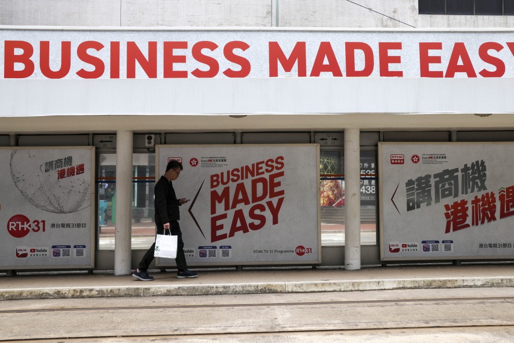 A man walks past an InvestHK advertisement at a tram stop in Taikoo on March 24. Photo: Jelly Tse